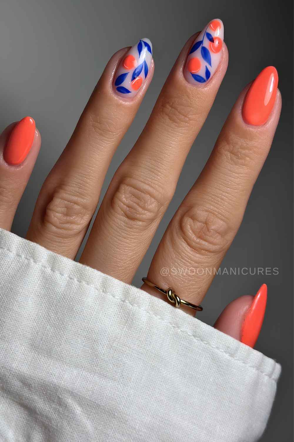 Orange and blue nails with fruit and leaf art