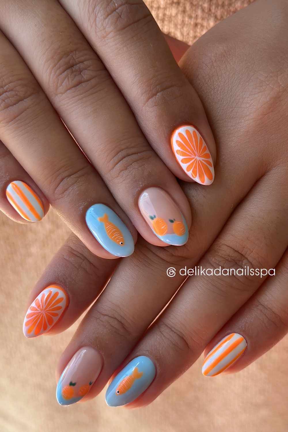 Orange and sky blue mani with fish and fruit art