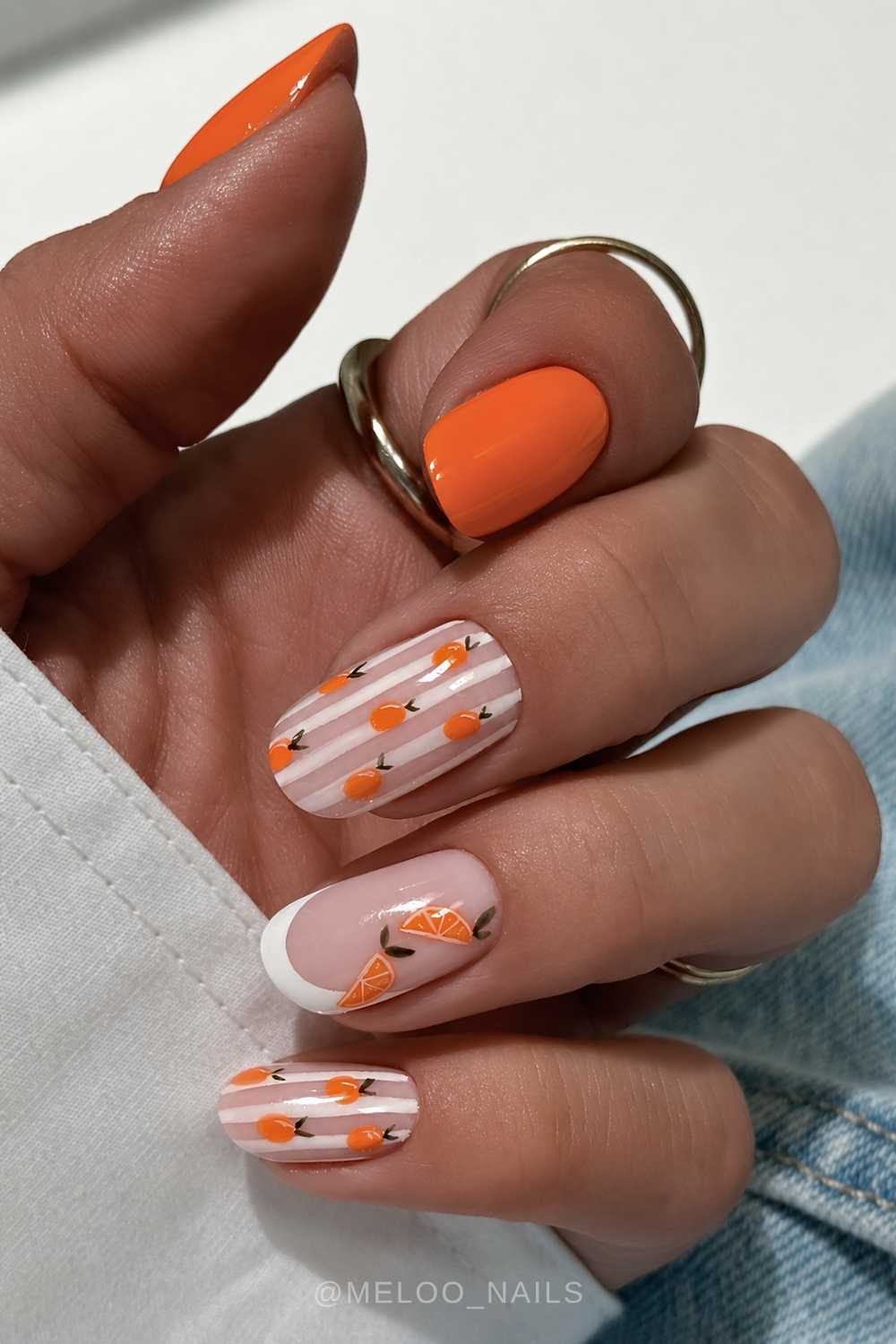 Orange and white mani with citrus and stripe accents