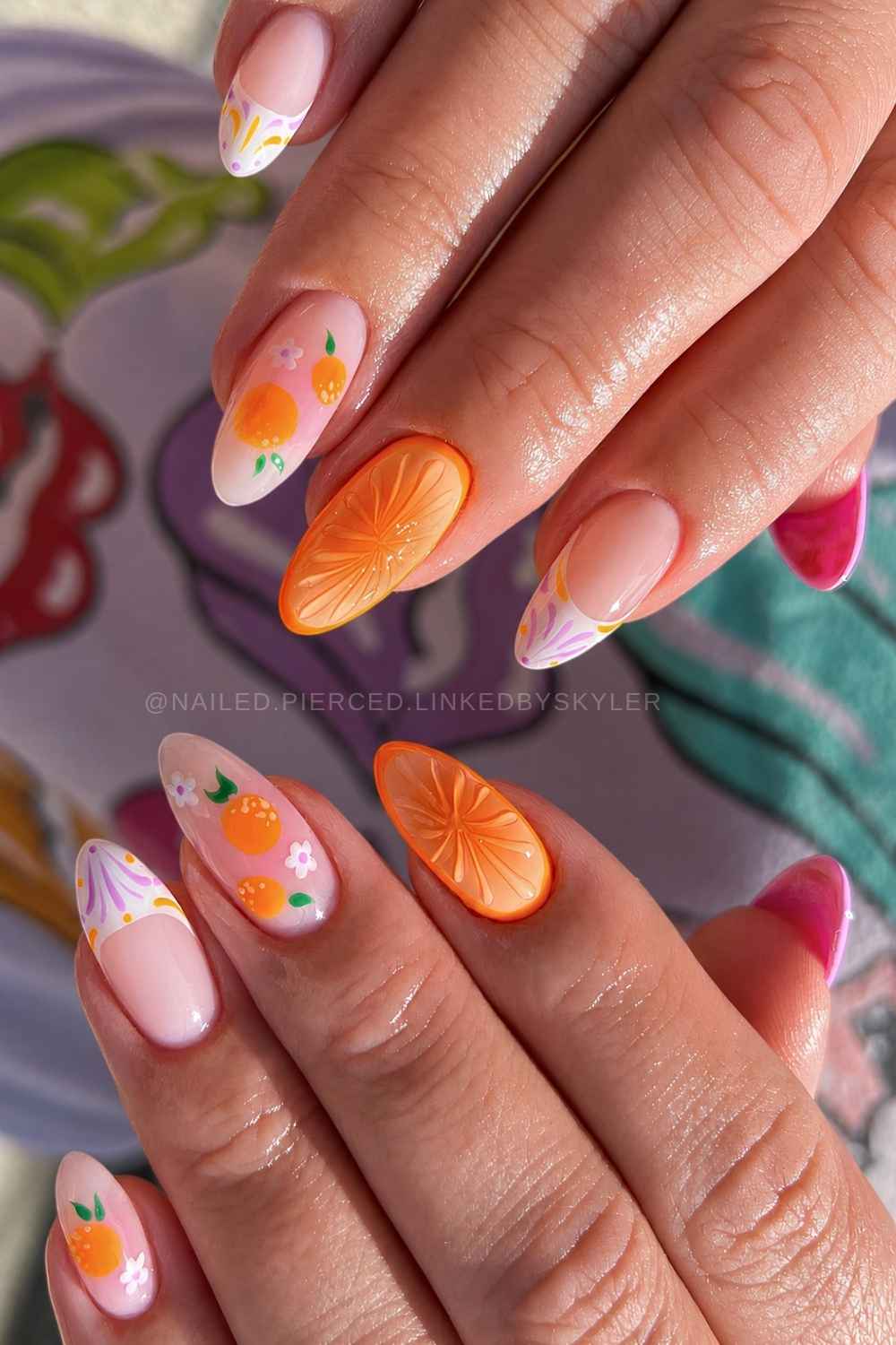 Orange nails with citrus and floral art