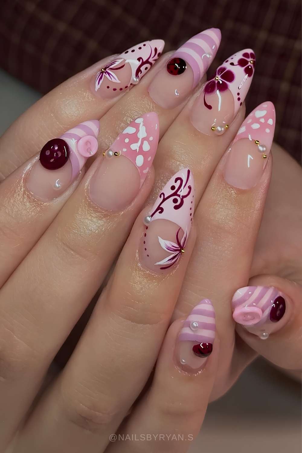 Pink and burgundy nails with flowers and button art