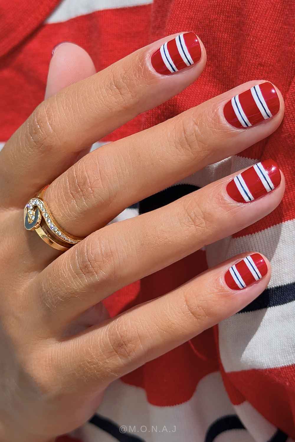Red nails with white and blue stripes