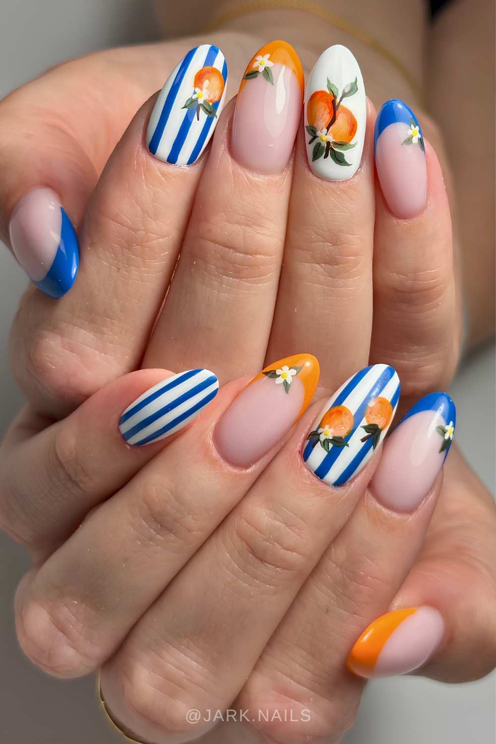 Royal blue and orange nails with stripes and citrus art
