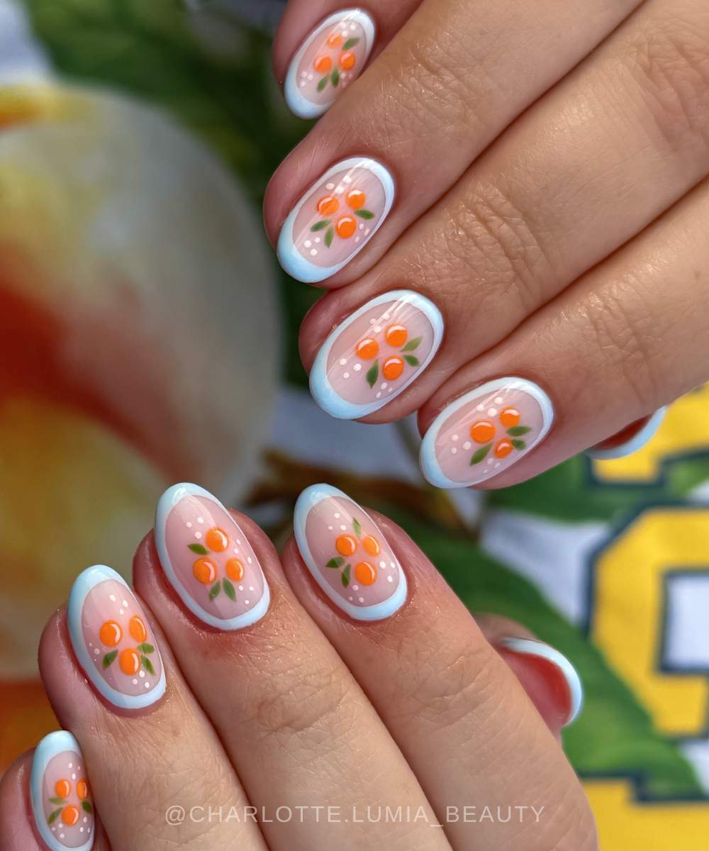 Sheer mani with orange art and blue outlines