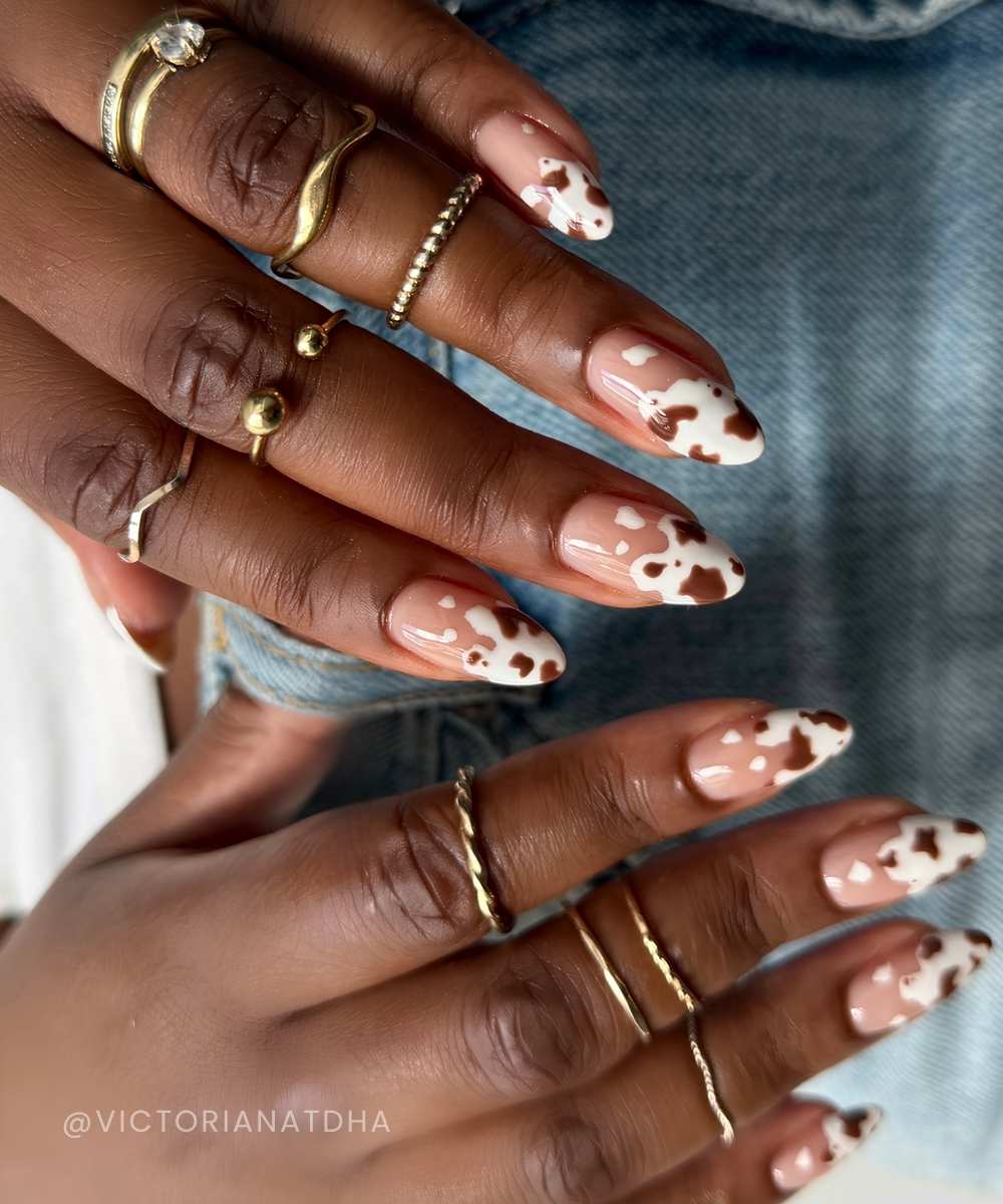 Abstract white French mani with brown cow print