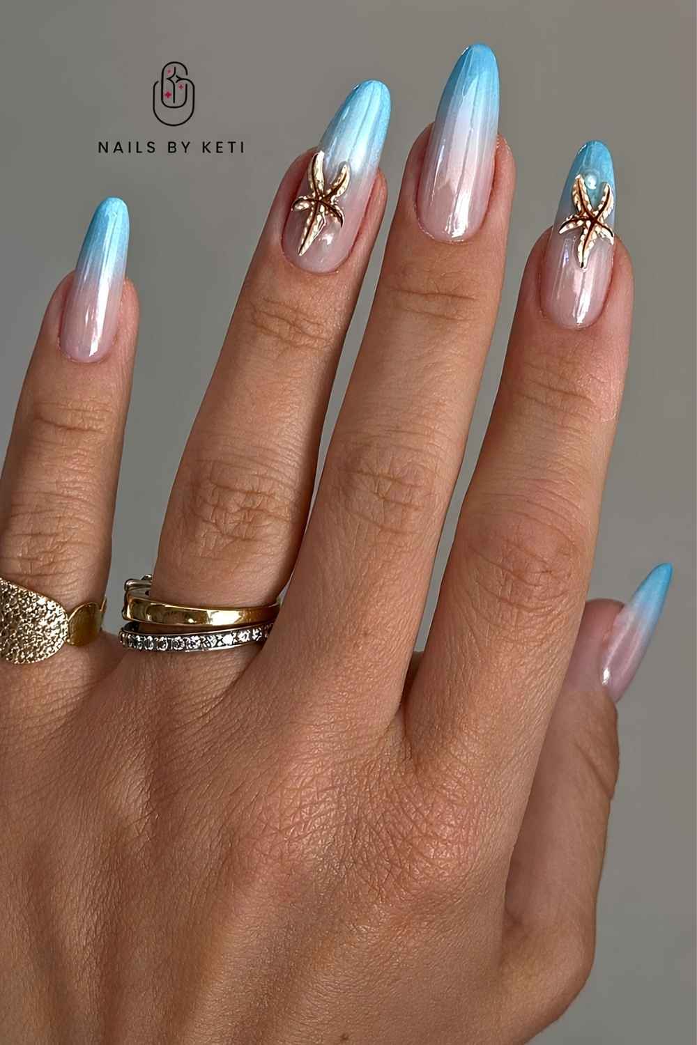 Blue chrome ombre nails with starfish art