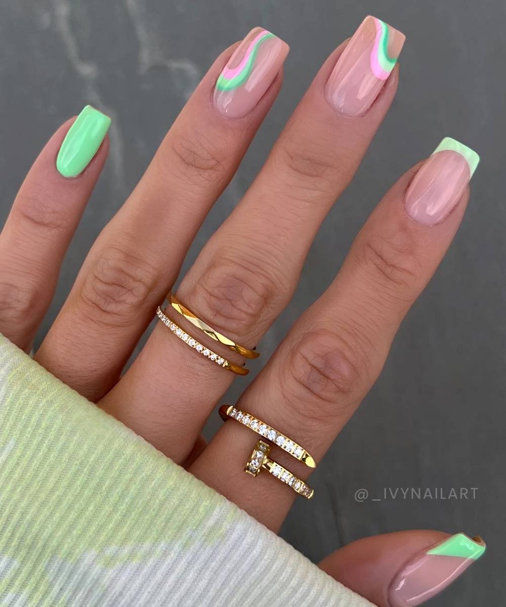 Bright green nails with pink swirl lines