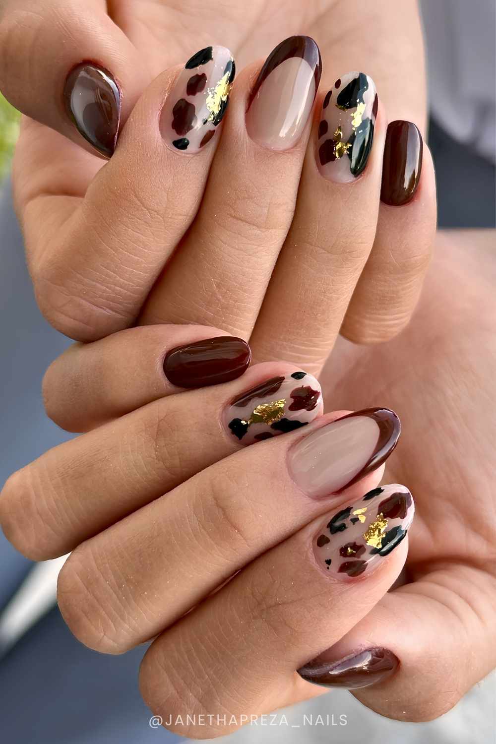 Brown cow print mani with gold foil accents