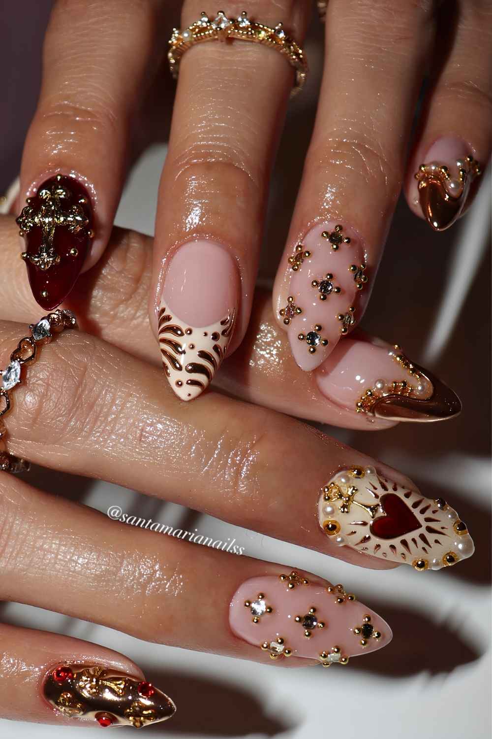 Burgundy and beige nails with gold baroque decorative motifs