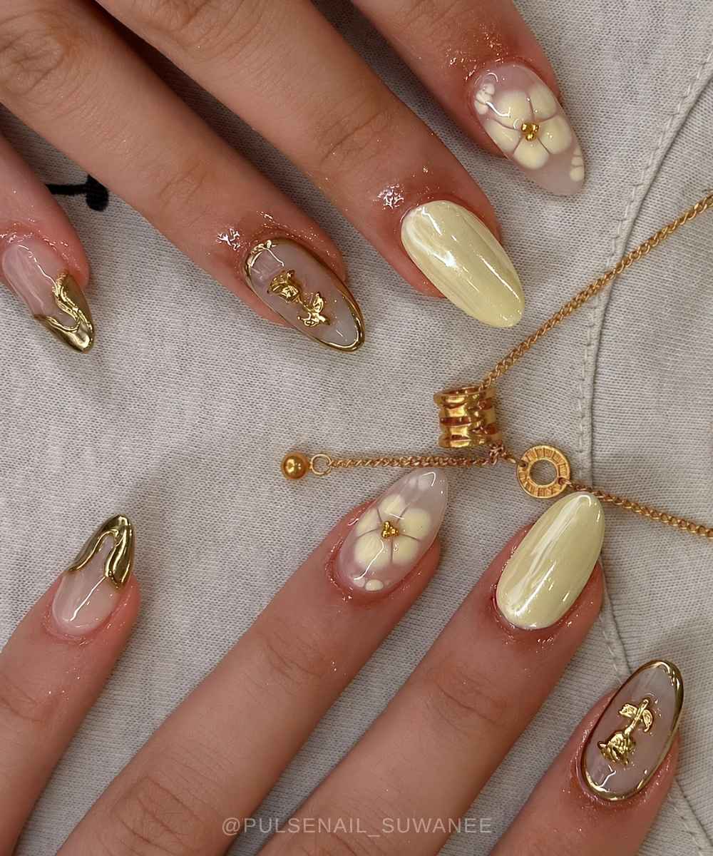 Butter yellow chrome nails with gold chrome art