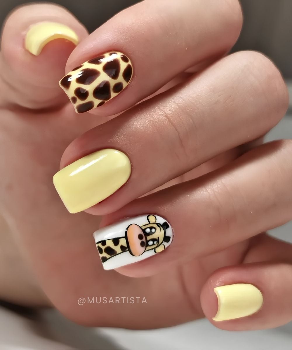Butter yellow nails with cute giraffe motifs