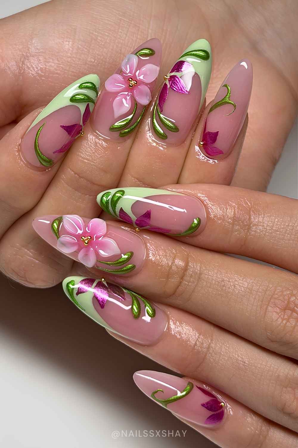 Green French mani with pink flowers and metallic swirls