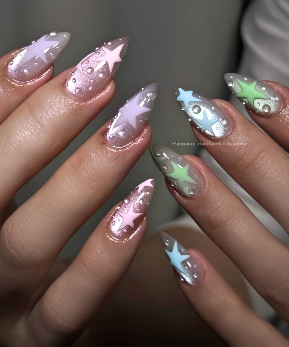 Green and pink cat eye nails with stars and dewdrops