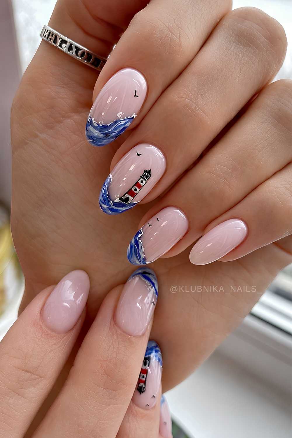Nautical French mani with lighthouse motifs