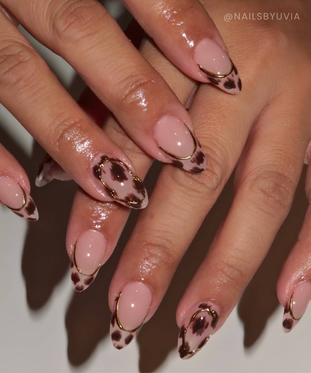 Neutral cow print French mani with gold accents
