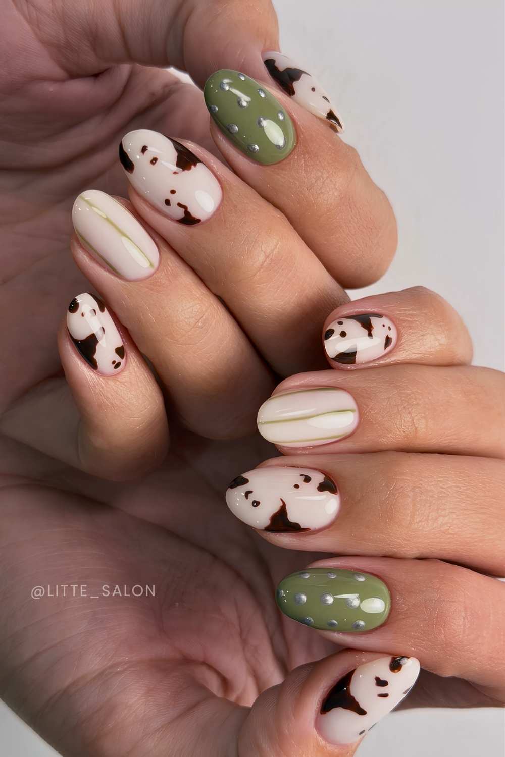 Olive and white nails with cow print and stripes