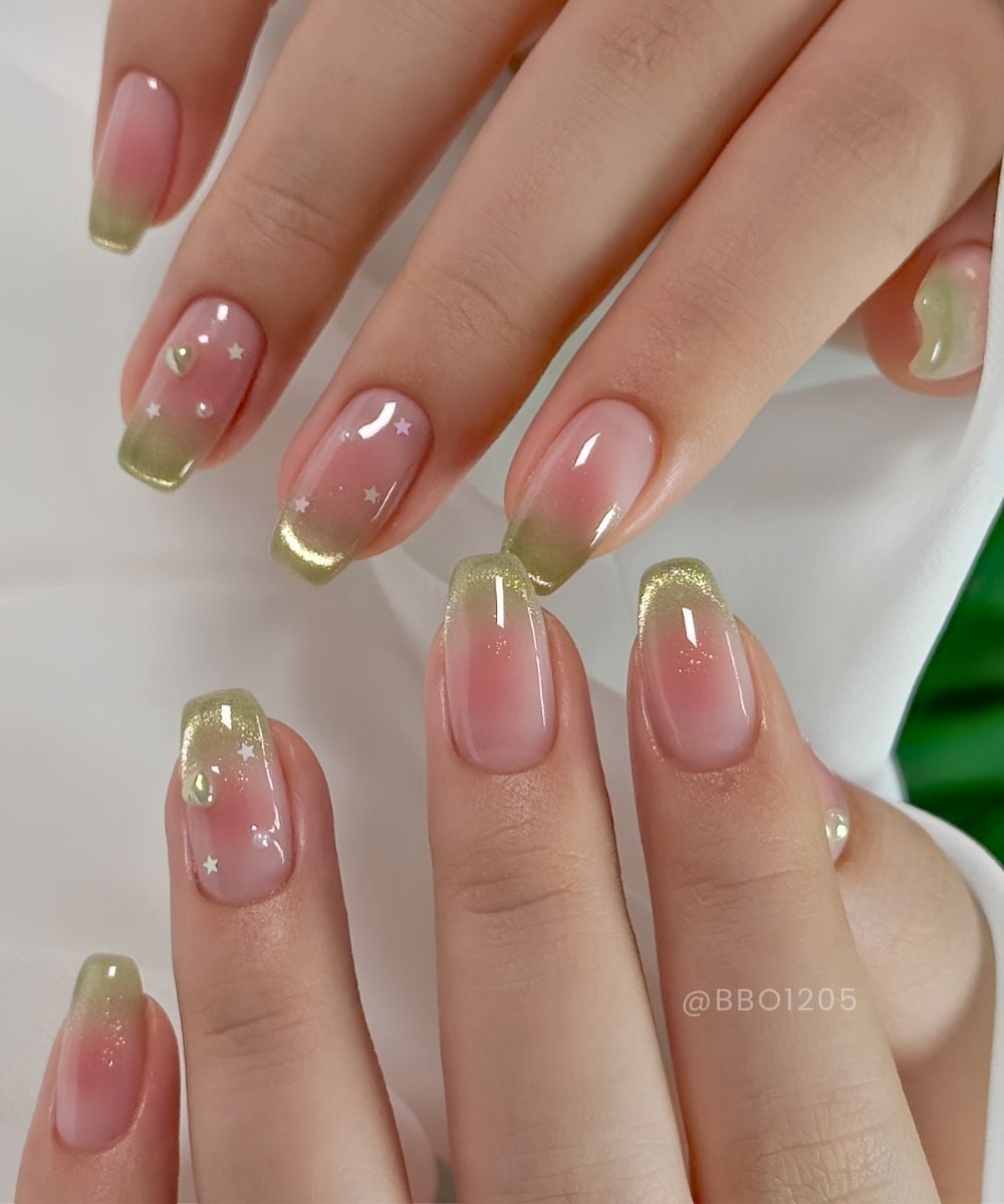 Pink and green cat eye nails with pearls and stars