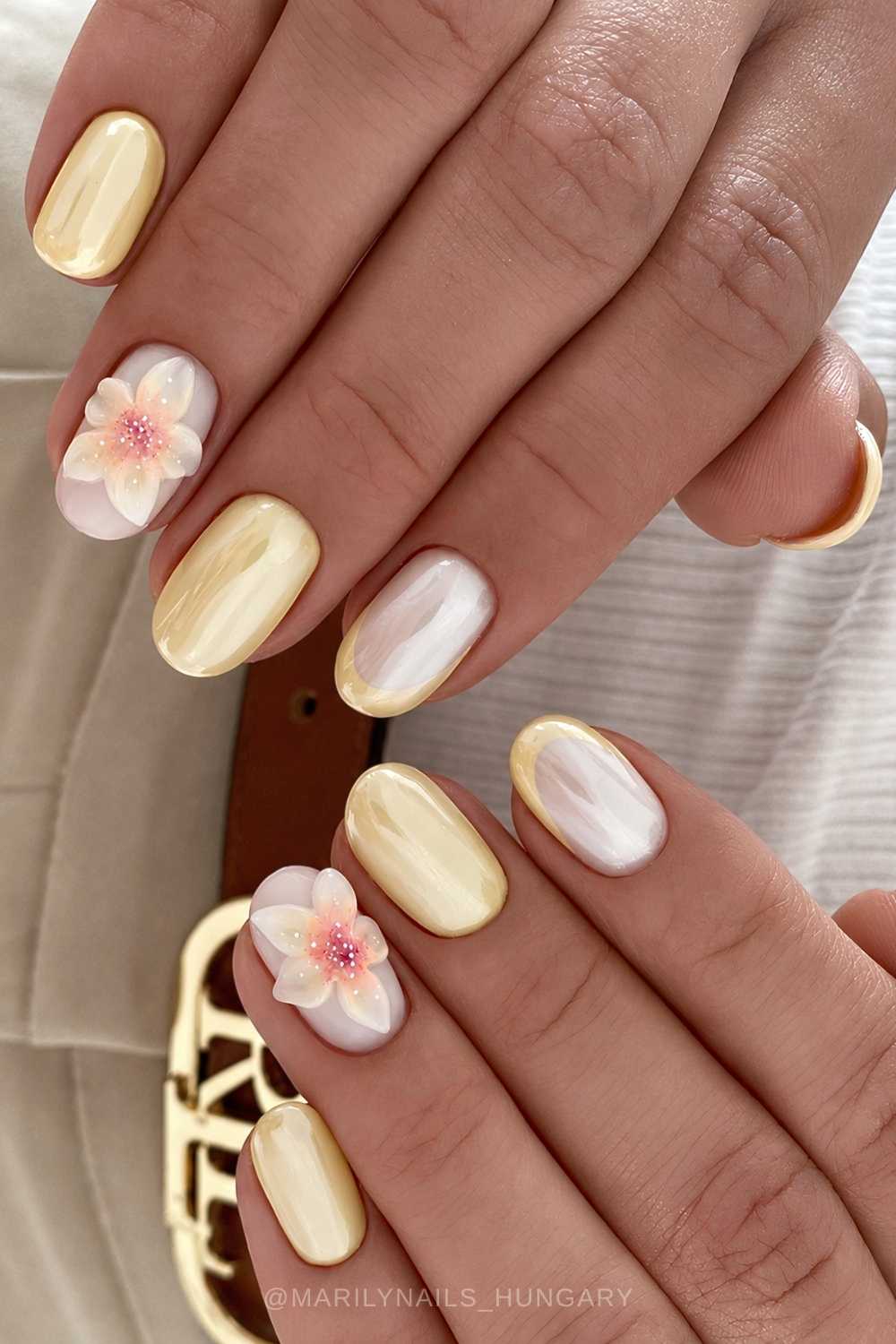 Short pastel yellow chrome nails with flowers
