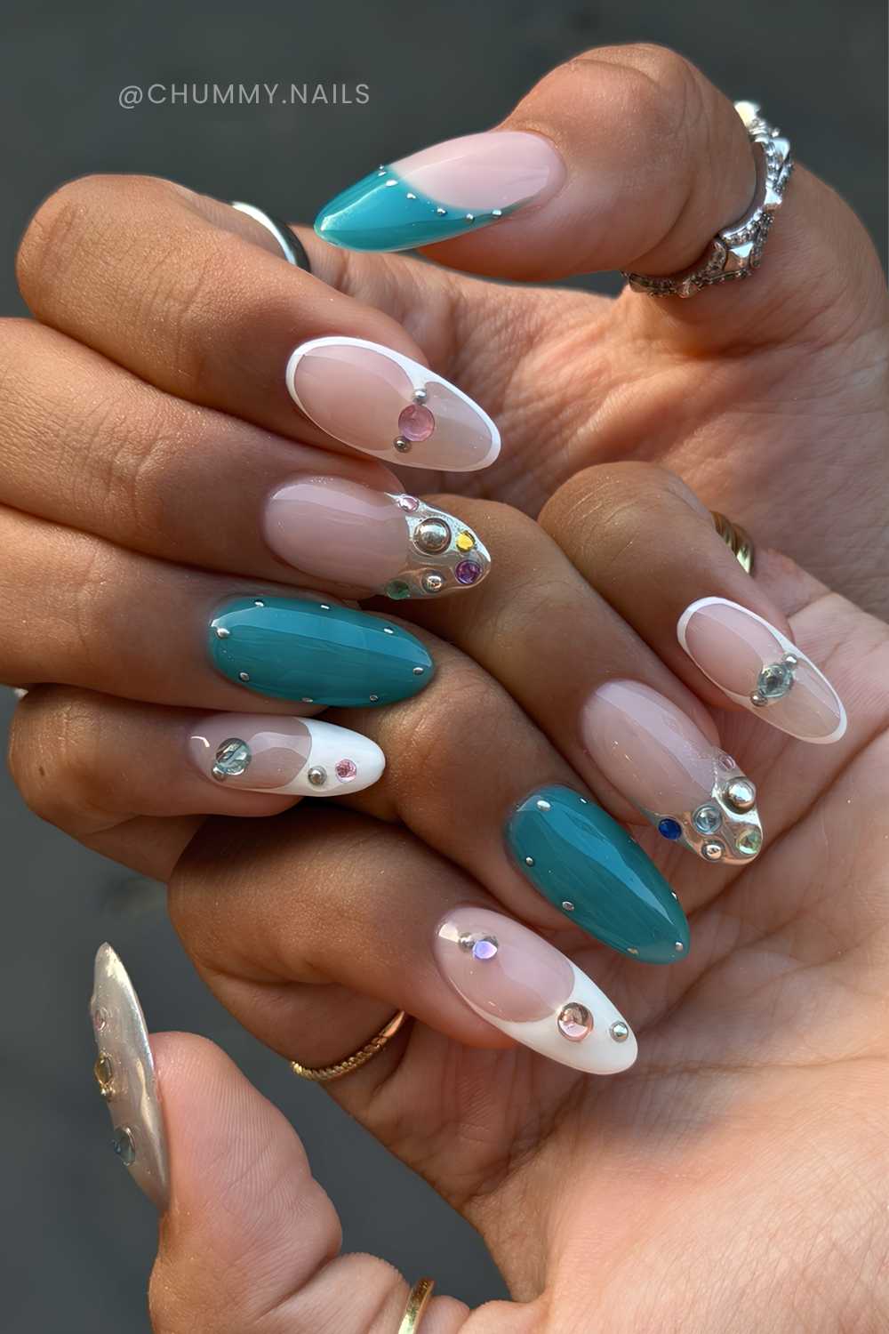 Teal and white nails with rhinestones