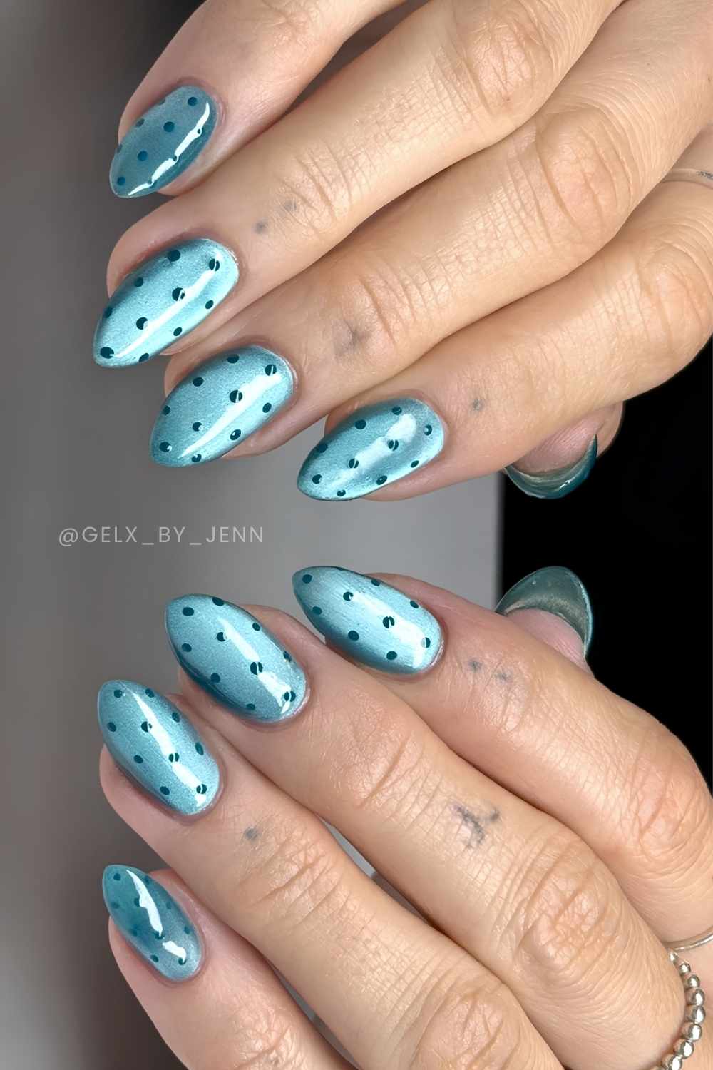 Teal cat eye nails with polka dots
