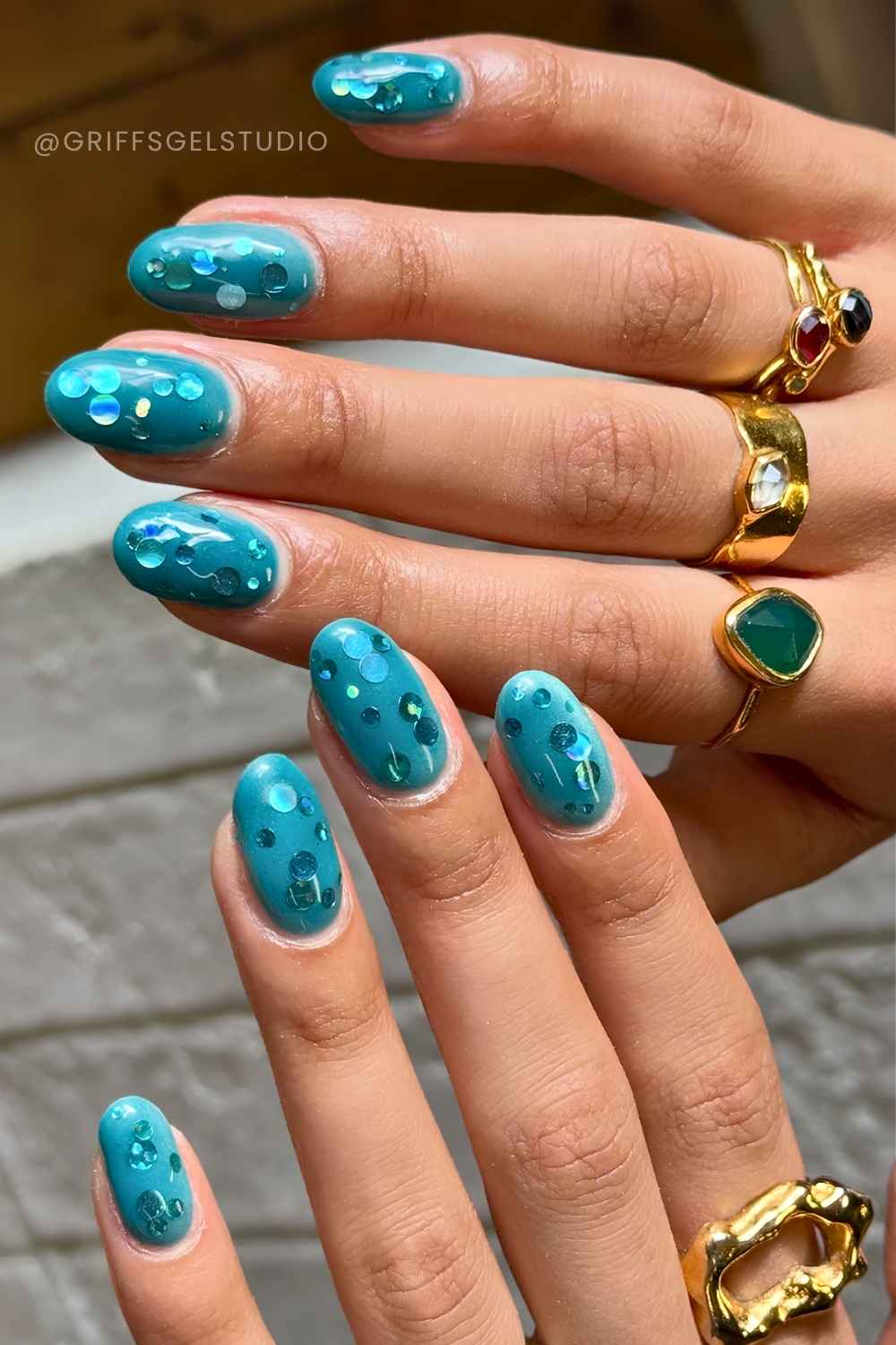 Teal nails with confetti accents