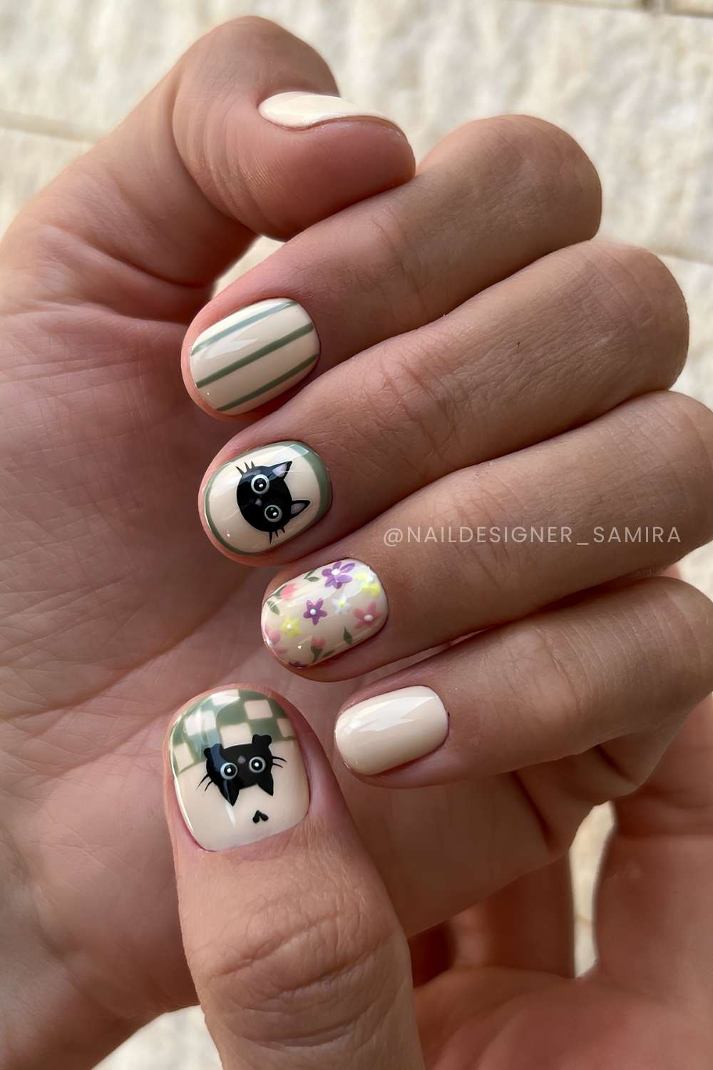 Vanilla nails with black cat art and green stripes