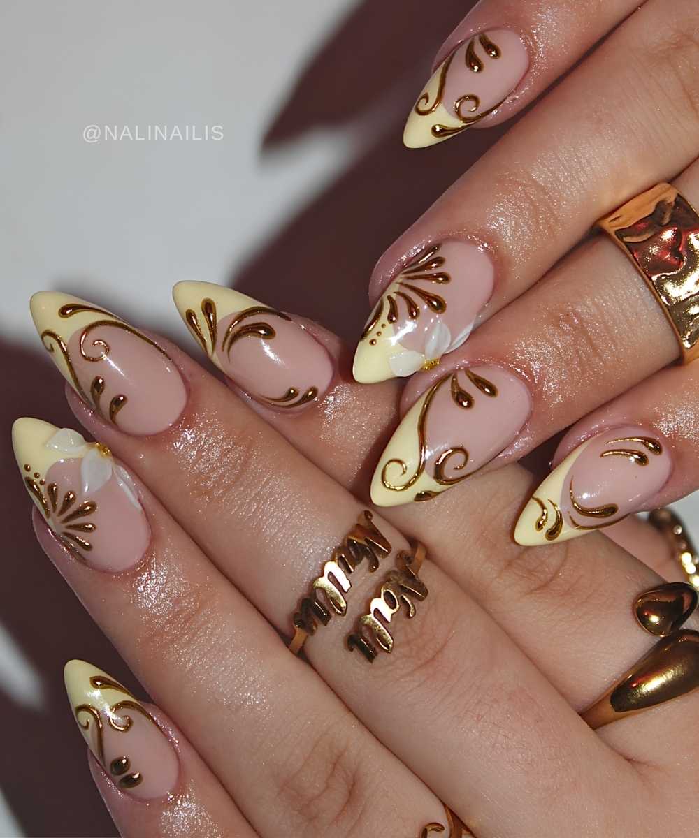 Yellow French mani with gold swirls and petals
