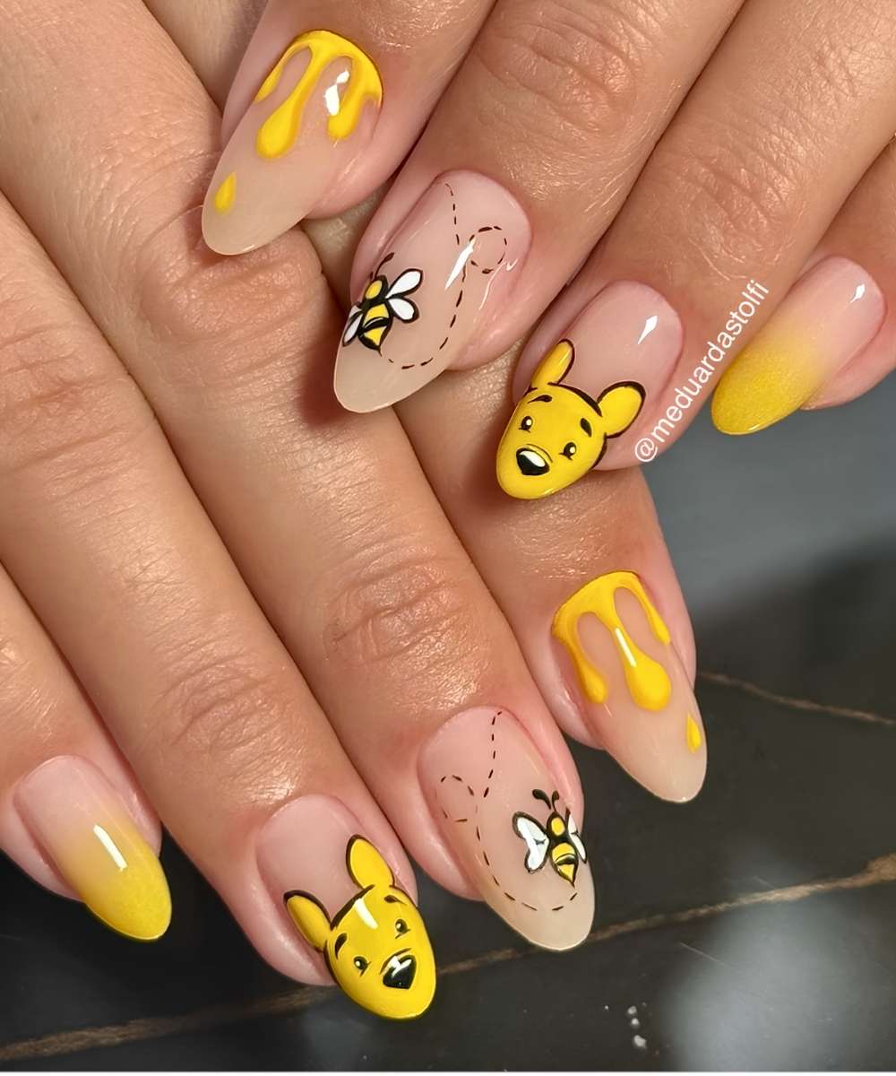 Yellow nails with Winnie the Pooh motifs