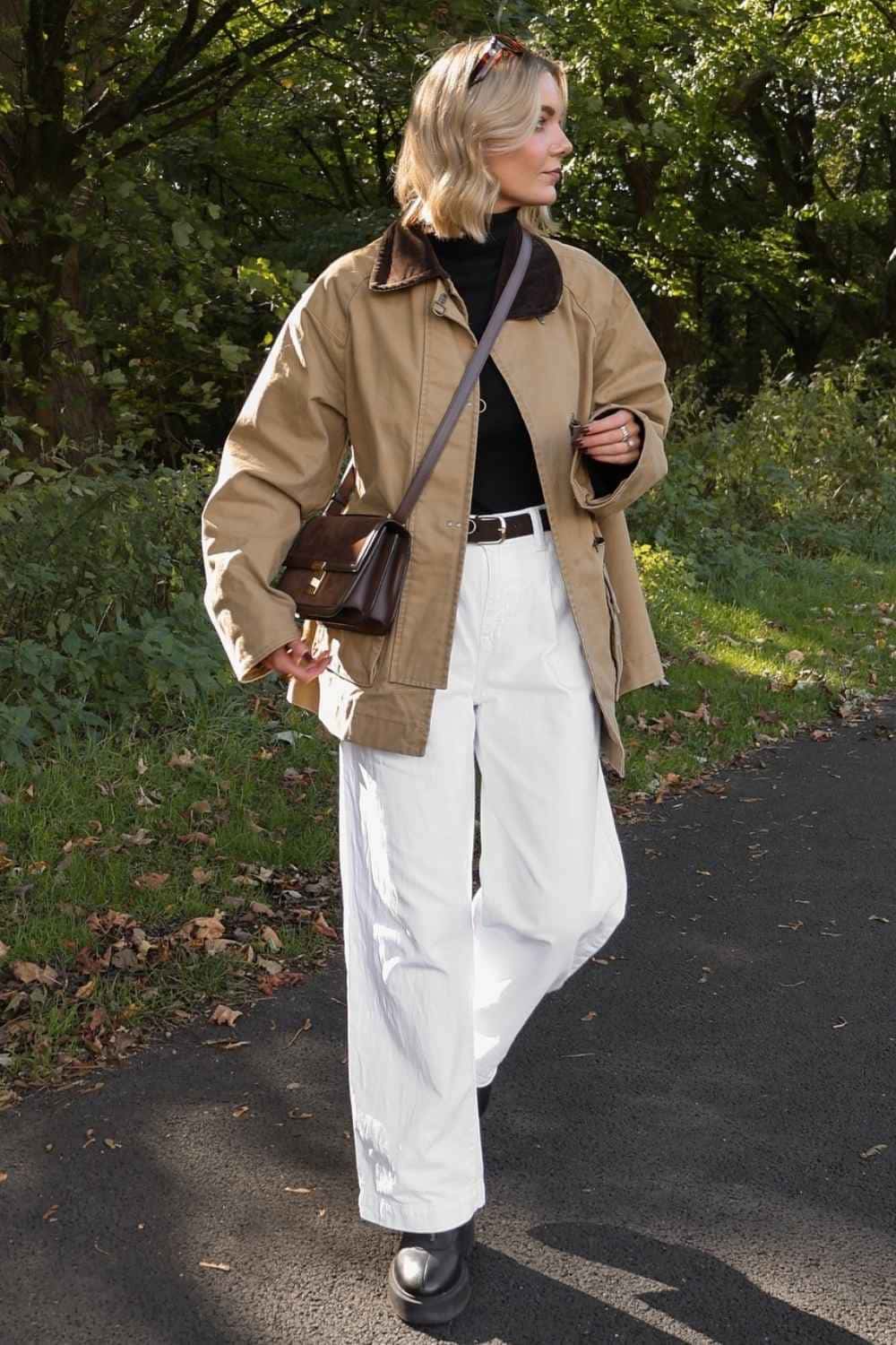 Barn jacket with black turtleneck and white jeans