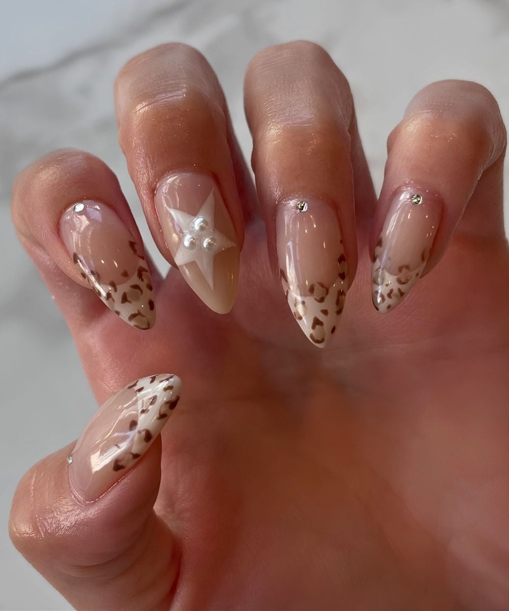 Beige French nails with leopard print and stars