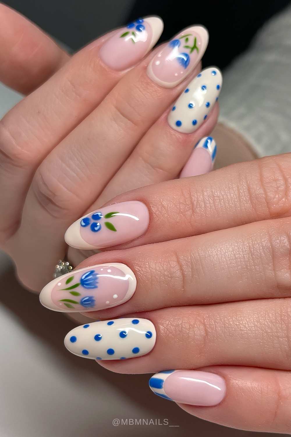 Beige manicure with blueberries and tulips