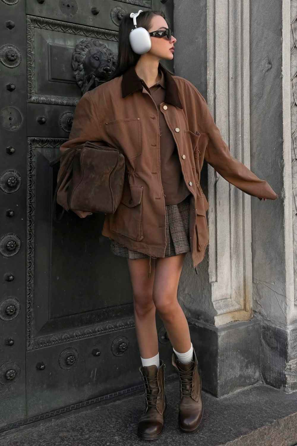 Brown barn jacket with brown shirt and plaid mini skirt