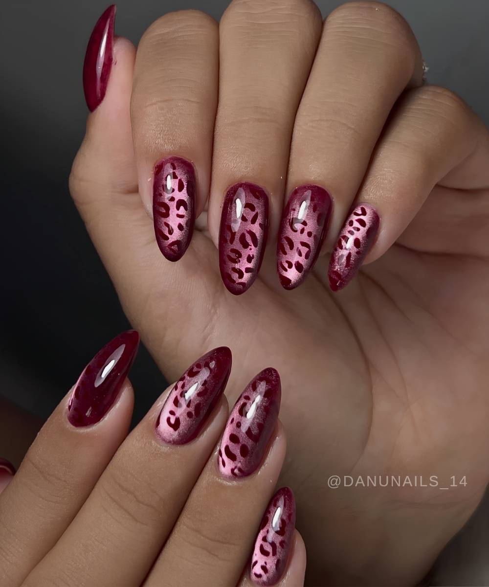 Deep red cat eye nails with animal print