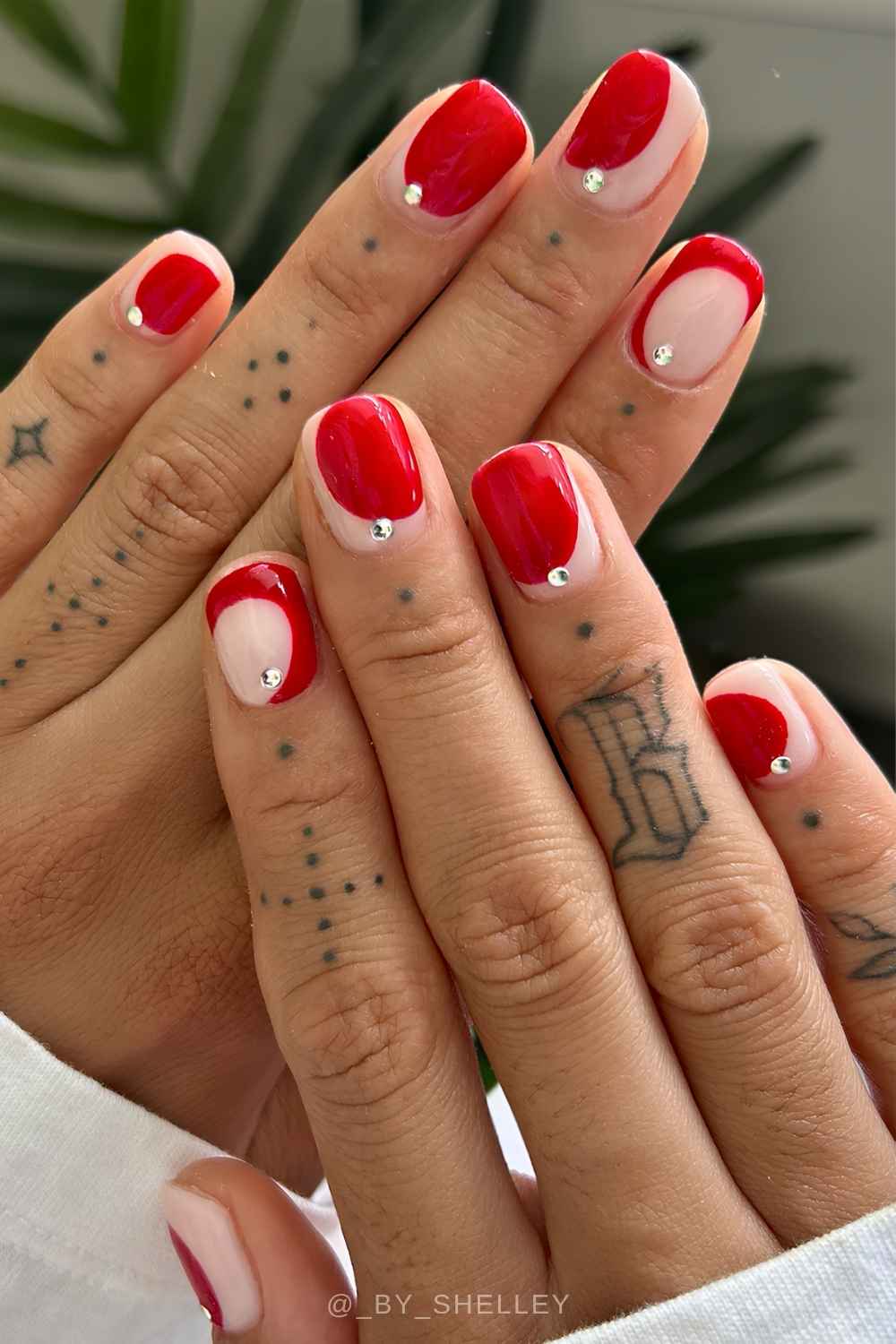 Red negative space nails with gems