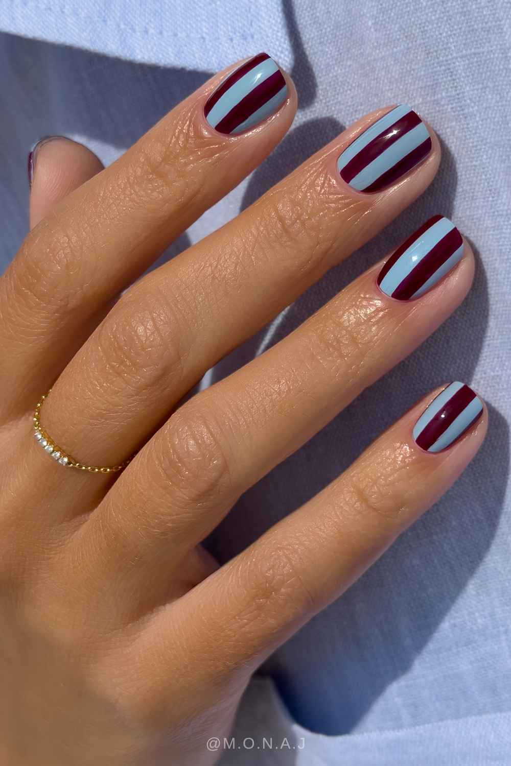 Short blue and bugundy striped nails