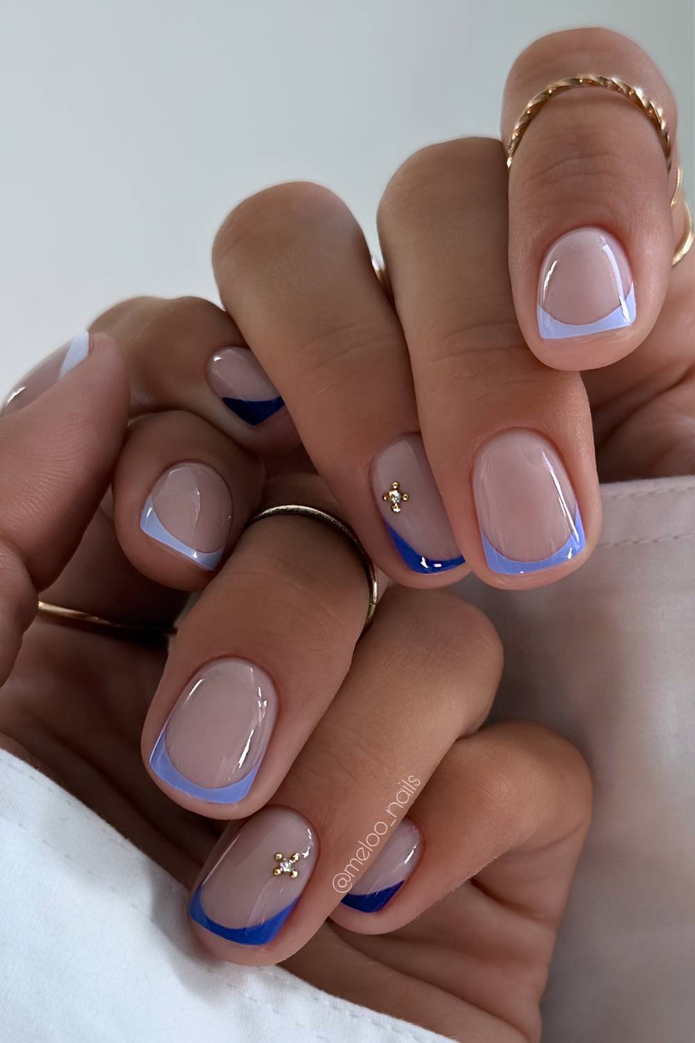Short blue skittle French tip mani