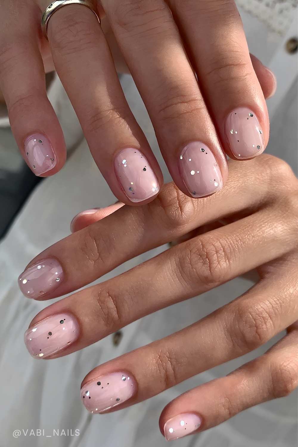 Short sheer nails with glitter finish