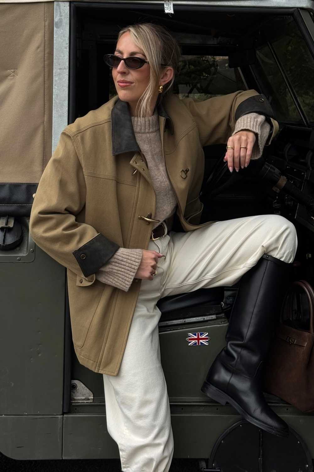 Tan barn jacket with cream jeans and black riding boots