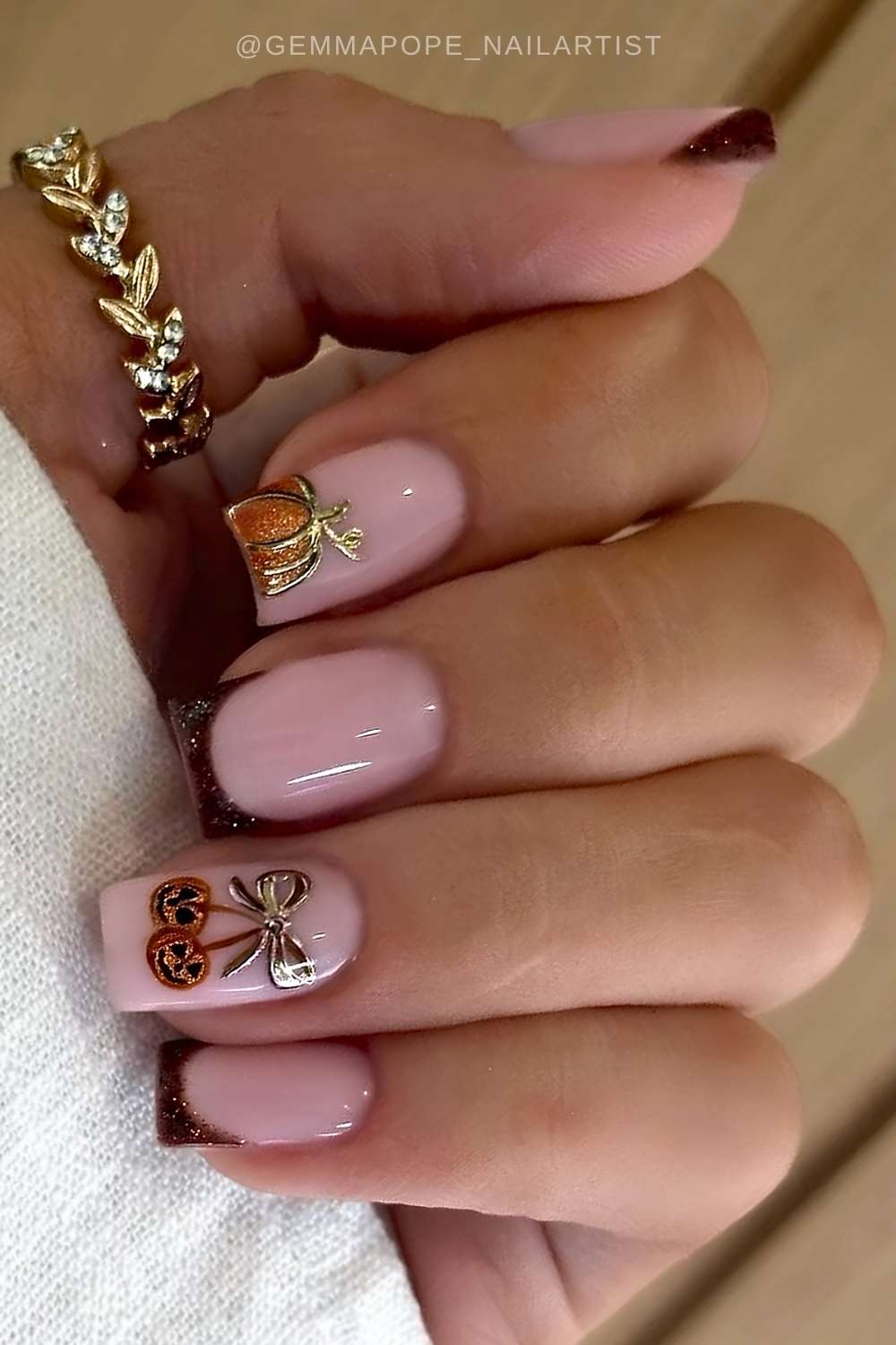 Brown French mani with cherry-style pumpkins
