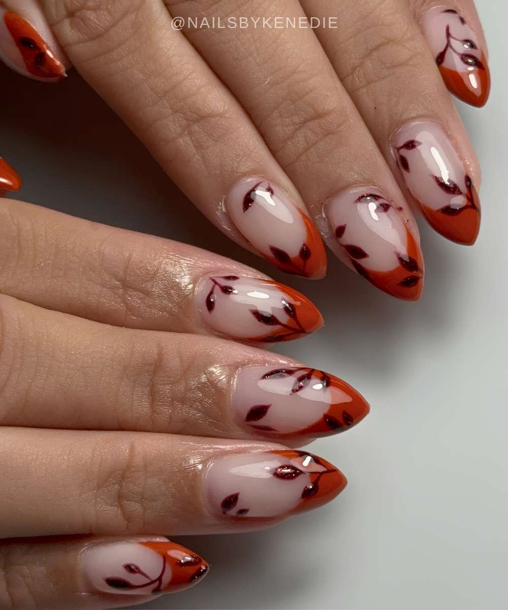 Burnt orange French nails with leaf accents
