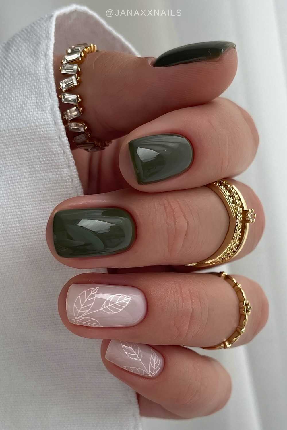 Dark green and white nails with leaf art