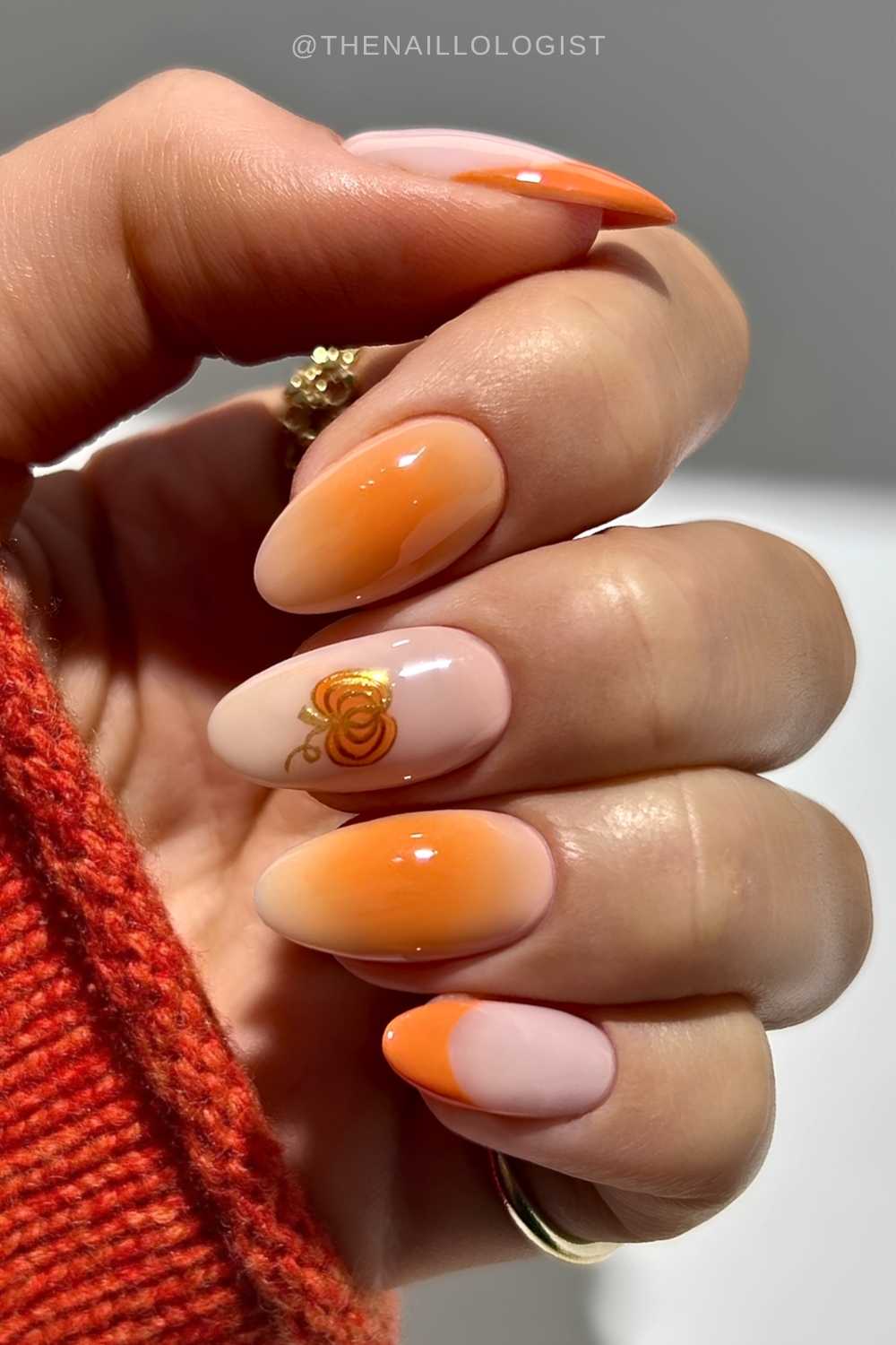Orange nails with pumpkin and aura accents