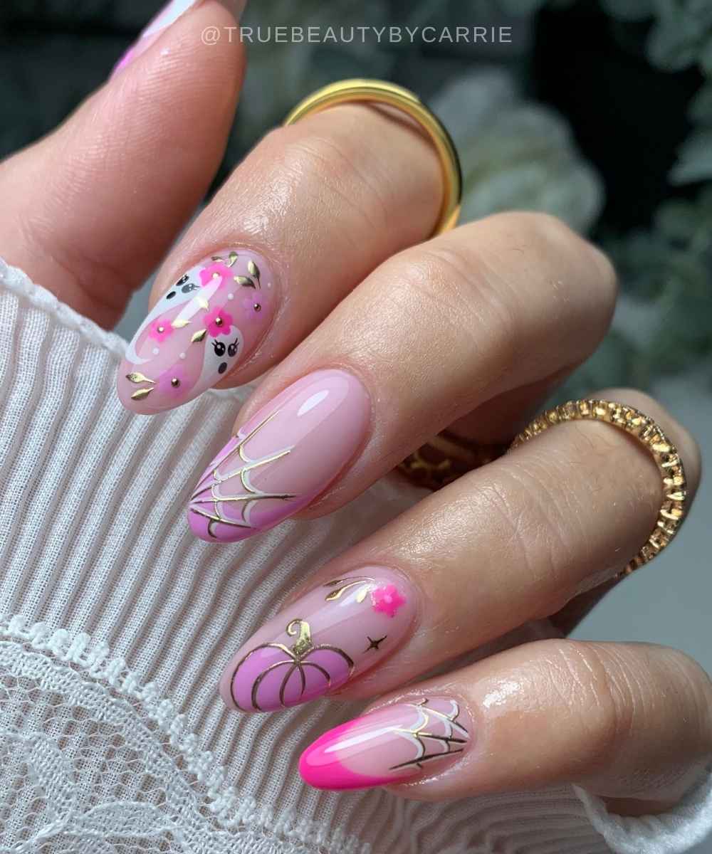 Pink Halloween nails with pumpkins and spiderwebs