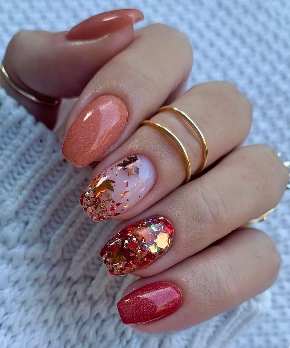 Red and orange mani with glitter and leaf accents