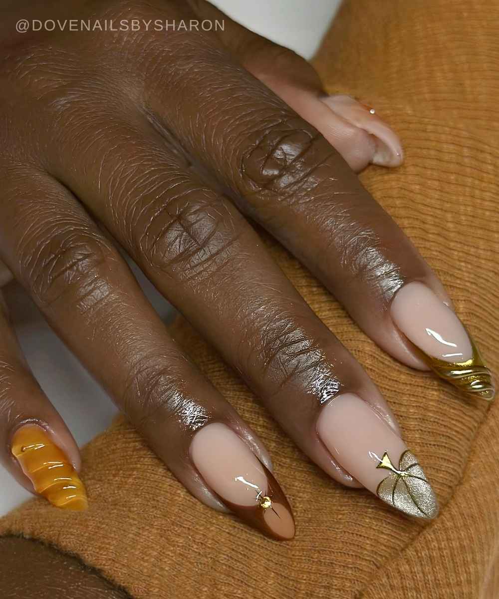Red and orange nails with pumpkins and gold details