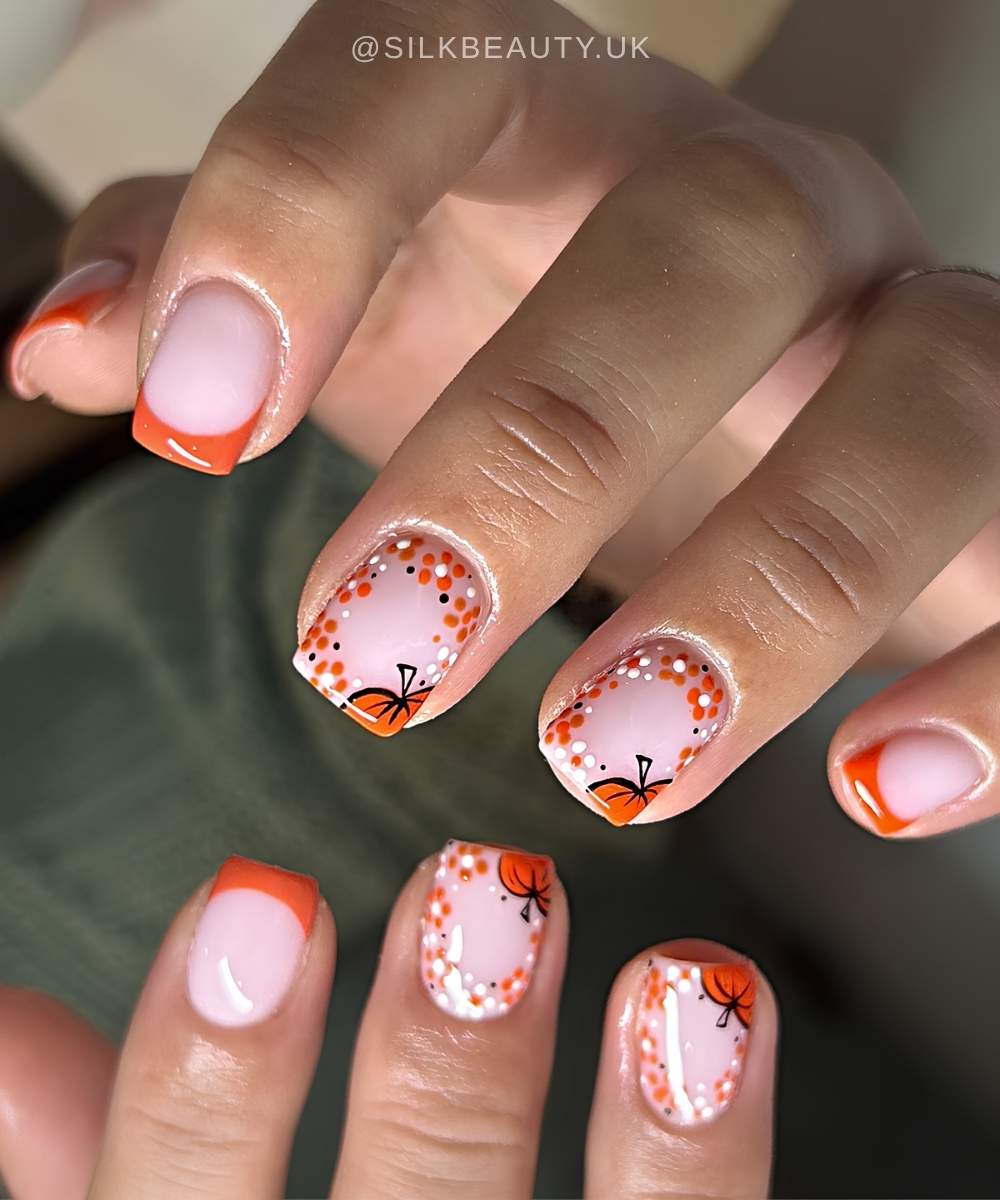 Short orange French mani with pumpkins